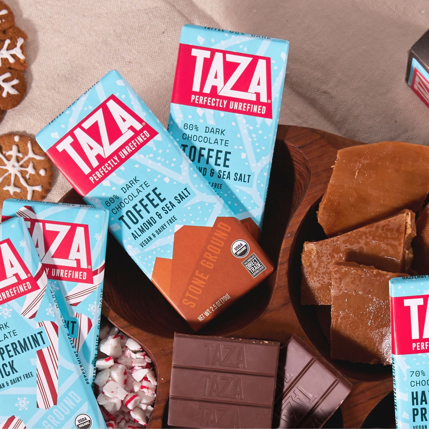 Wrapped Toffee Almond & Sea Salt bars next to toffee and unwrapped chocolate.