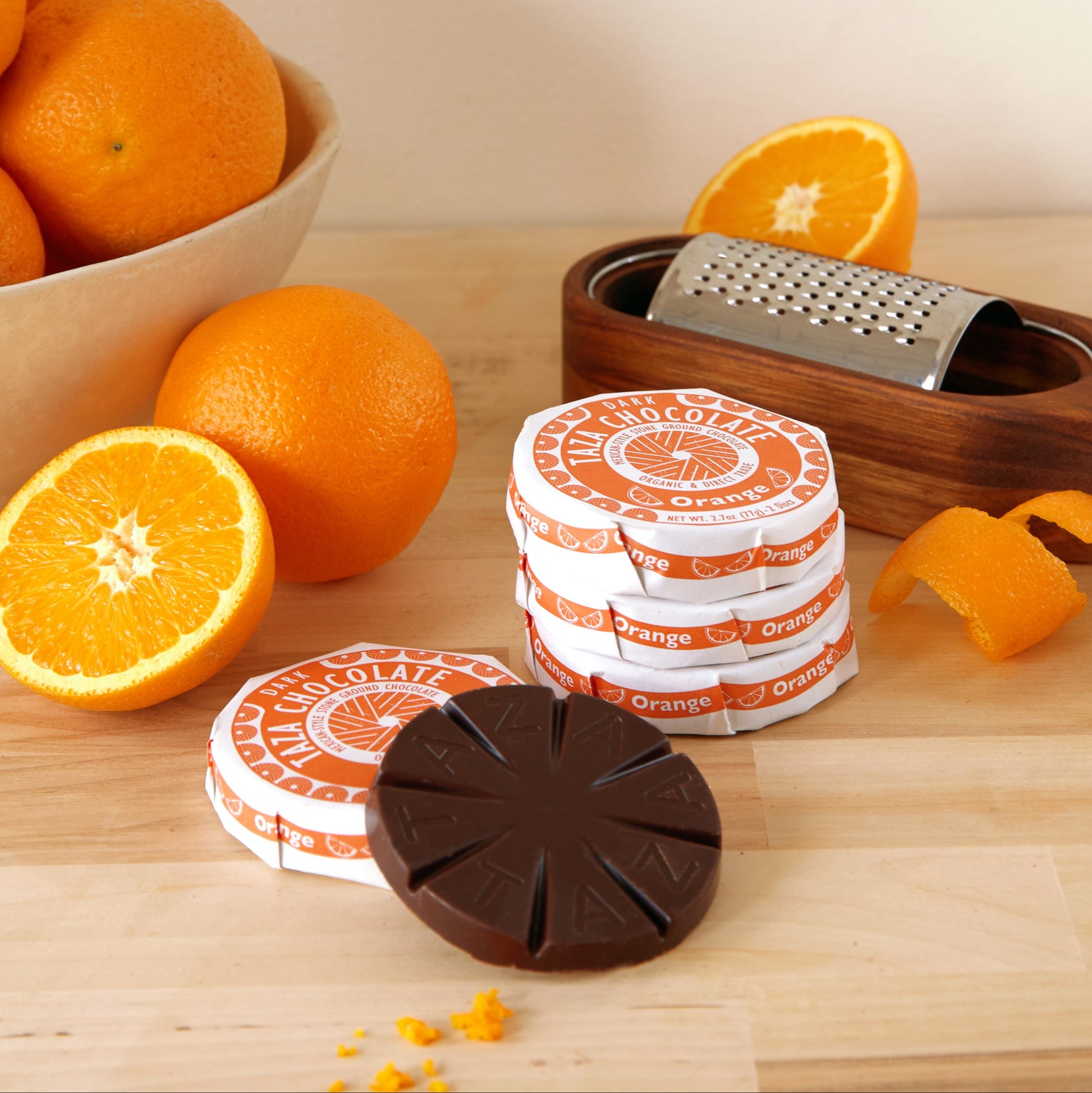 Orange Discs wrapped and unwrapped amongst orange slices