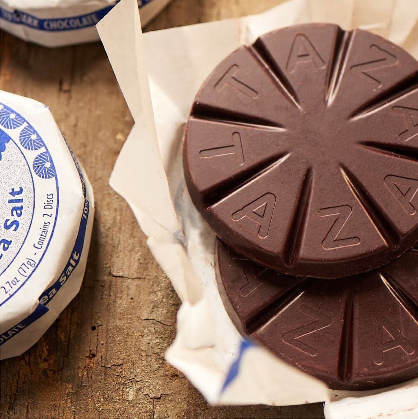 Closeup of unwrapped Sea Salt Chocolate Disc.