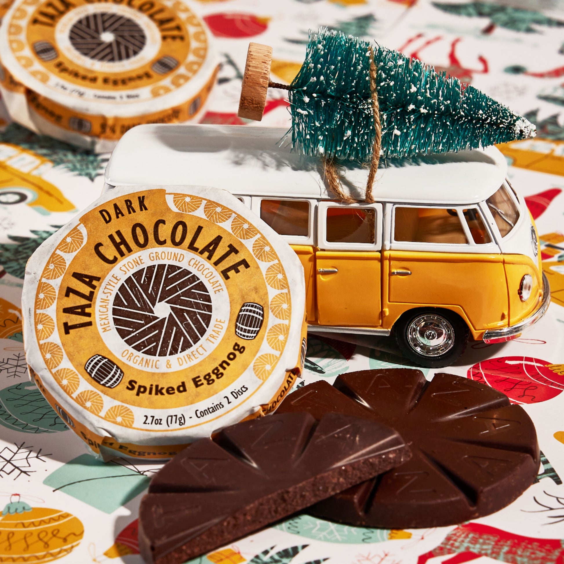 Close up shot of a wrapped and unwrapped Spiked Eggnog Chocolate Disc in a holiday themed place setting.