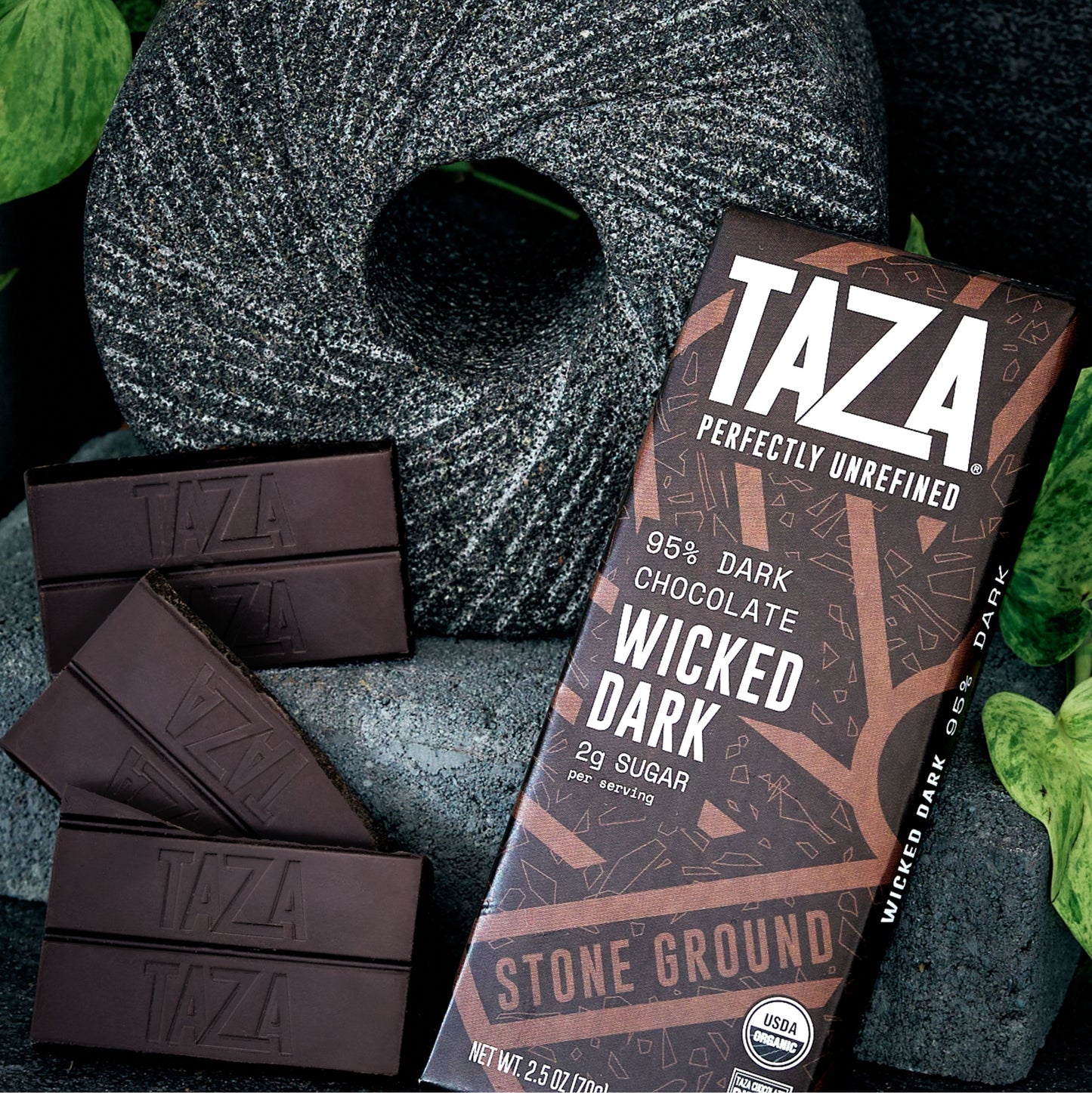 Closeup of a Wicked Dark Bar next to unwrapped chocolate.