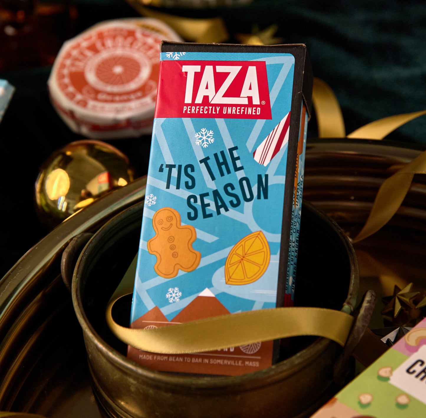Taza chocolate 4 Bar Bundle packaging with 'Tis the Season design on a decorative background