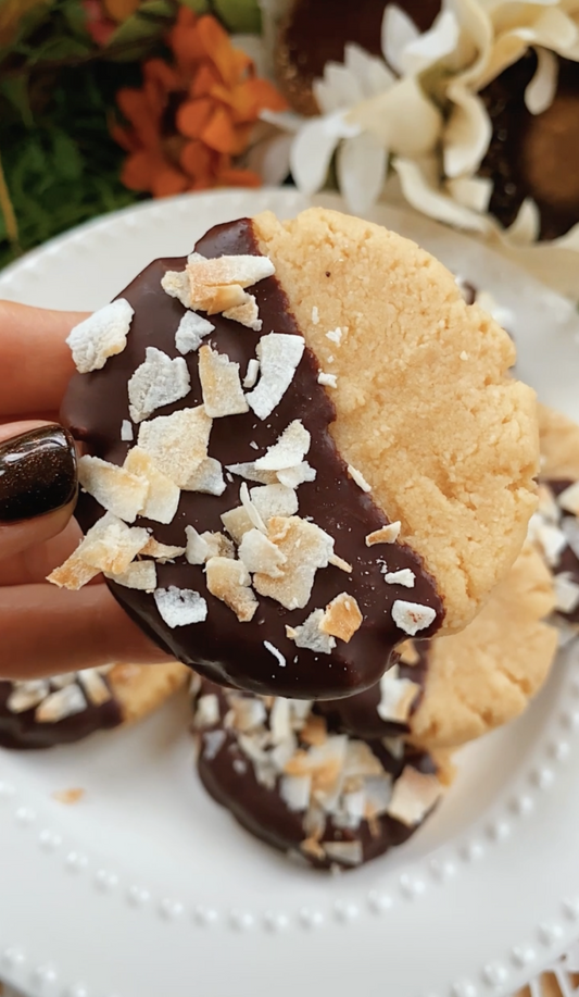 shortbread cookie dipped in chocolate and coconut flakes
