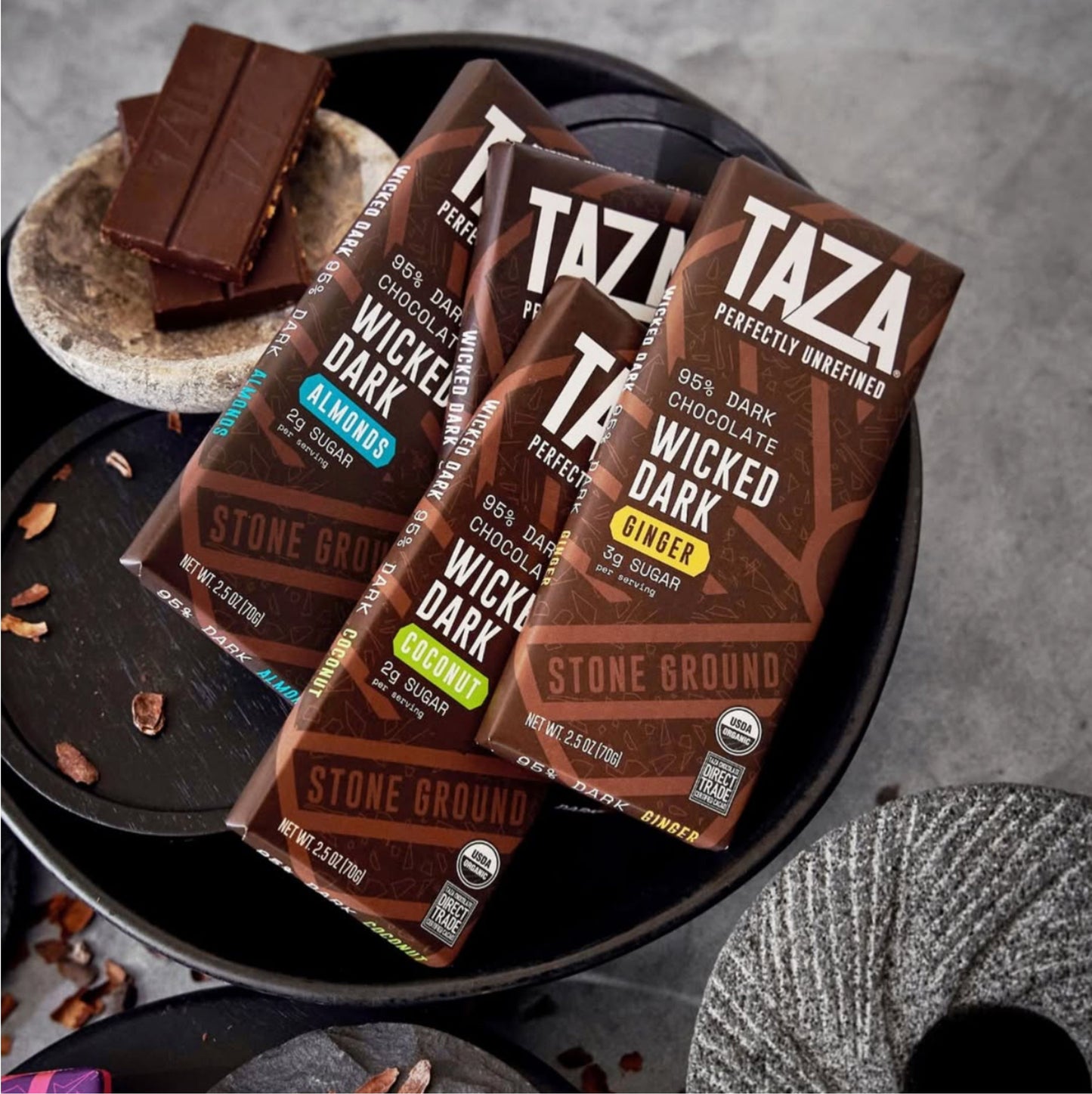 Wicked Dark Coconut Bar lying amongst similar products and unwrapped chocolate.