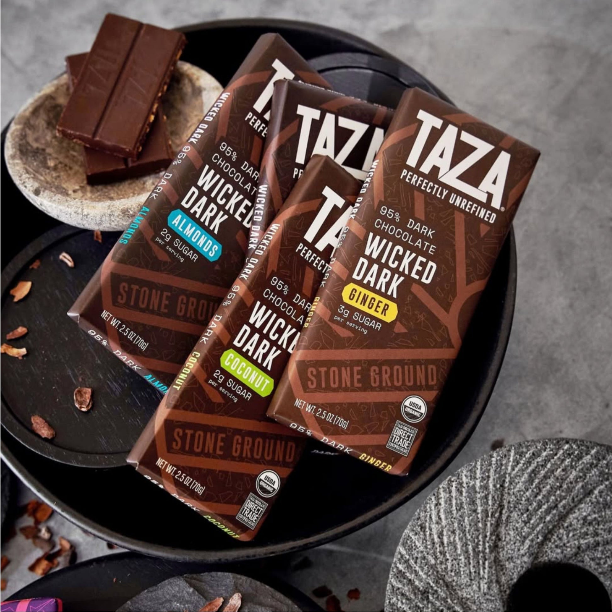 Wicked Dark Coconut Bar lying amongst similar products and unwrapped chocolate.